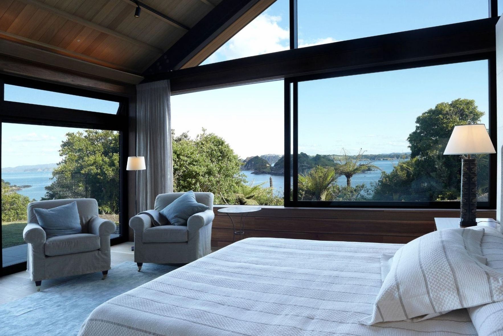 Luxury suite interior with panoramic mountain view, fireplace and native timber furnishings